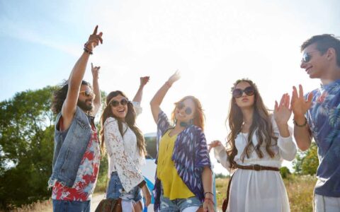 Happy Young Hippie Friends Dancing Over Minivan Car Outdoors