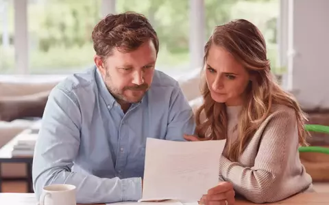 Worried looking couple reviewing documents