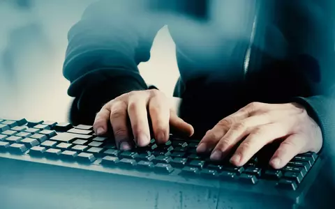 Cyber Criminal typing on keyboard