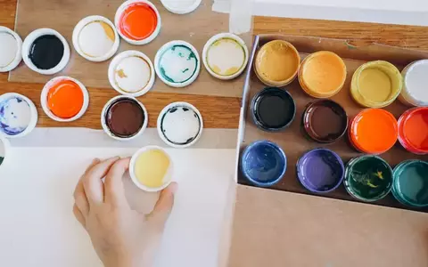 Child's hand selecting a paint